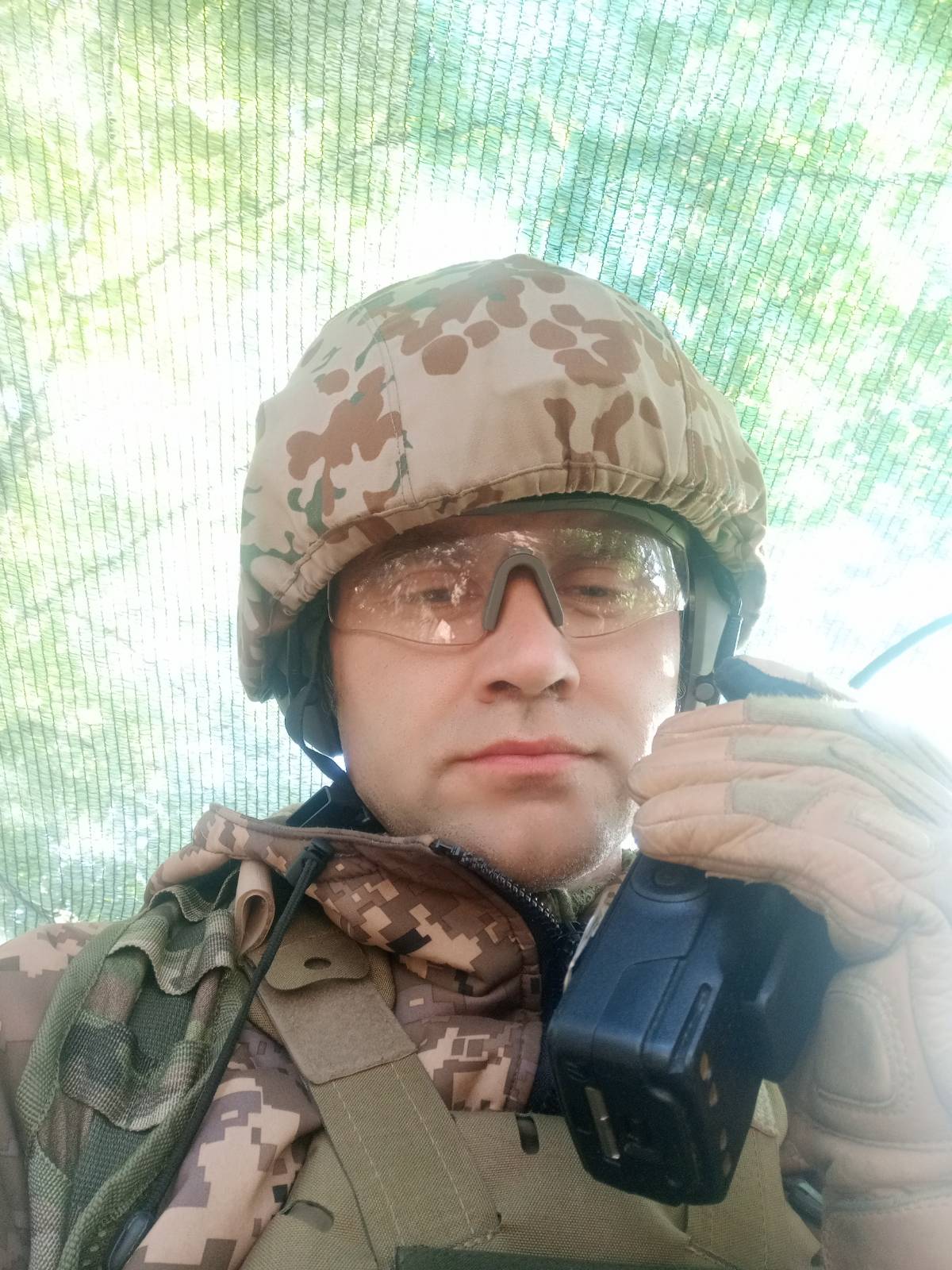 Chaplain Viacheslav using radio communications in the field