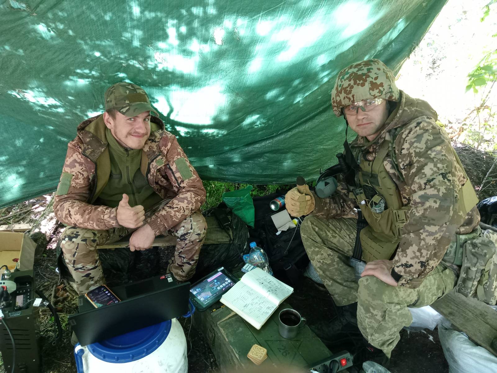 Soldiers at a field station with electronics and communications equipment